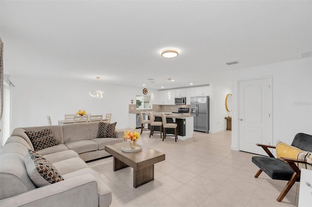 living area featuring recessed lighting, visible vents, and light tile patterned floors