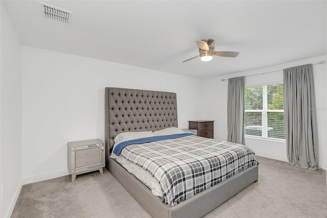 bedroom featuring light carpet, baseboards, visible vents, and a ceiling fan