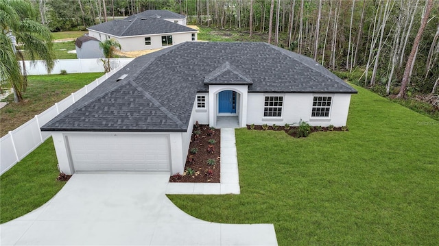 view of front of home with a front yard, fence, and roof with shingles