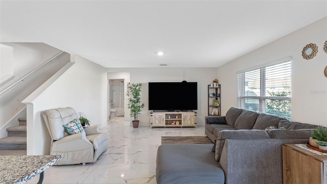 living area with marble finish floor, stairway, and recessed lighting