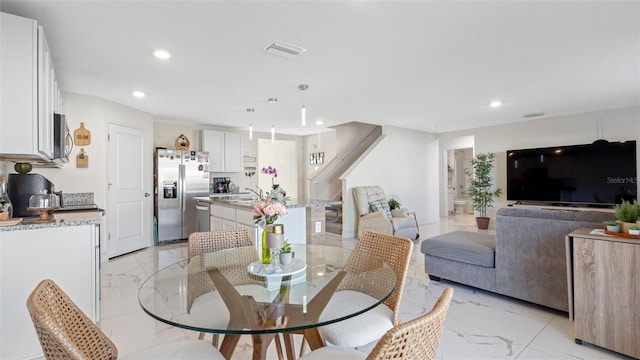 dining space featuring marble finish floor, visible vents, and recessed lighting