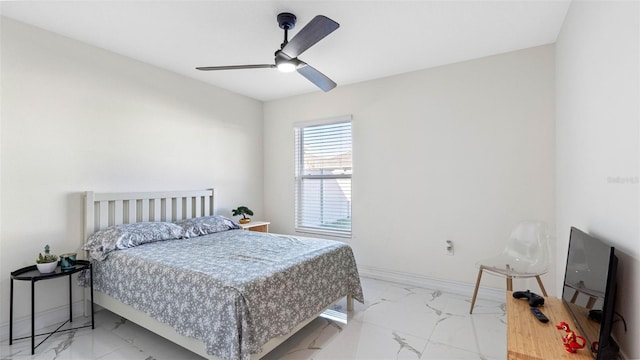 bedroom featuring a ceiling fan, marble finish floor, and baseboards