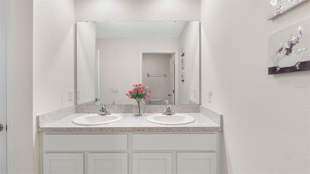 full bath featuring double vanity and a sink