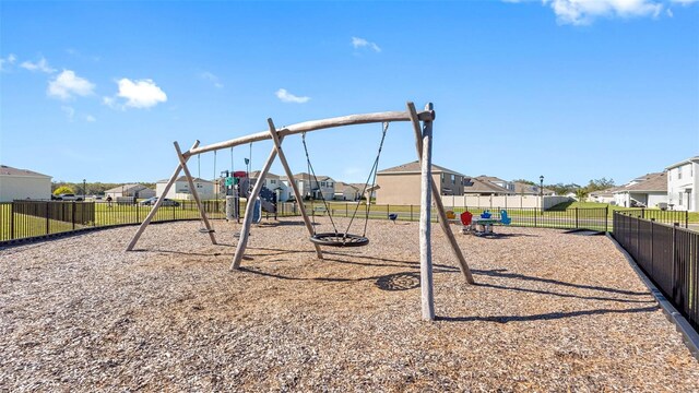 community playground with a residential view and fence