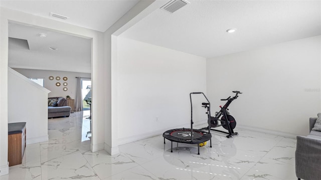 workout room with marble finish floor, visible vents, and baseboards