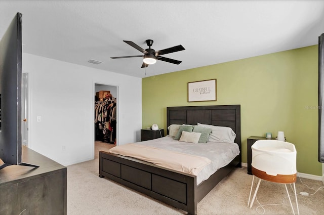 4544 Teoli Ct, Kissimmee, FL 34746 - bedroom with light colored carpet, visible vents, a ceiling fan, a closet, and a walk in closet