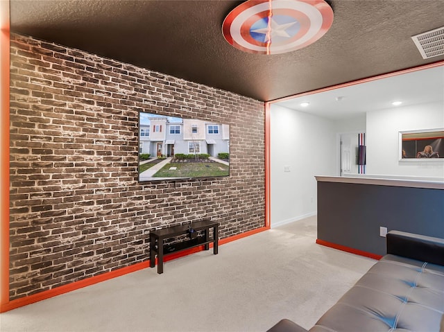 living room featuring light colored carpet, visible vents, a textured ceiling, brick wall, and baseboards