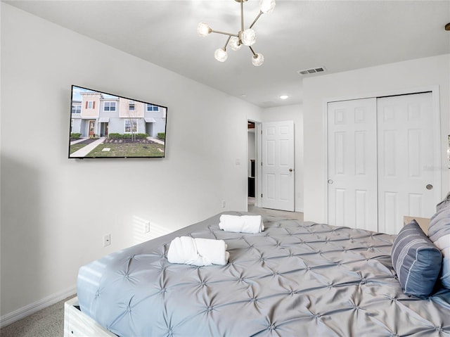 unfurnished bedroom featuring a closet, visible vents, an inviting chandelier, light carpet, and baseboards