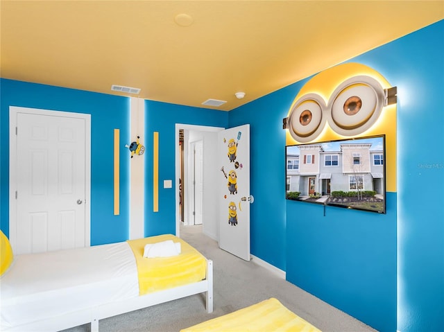 carpeted bedroom featuring visible vents