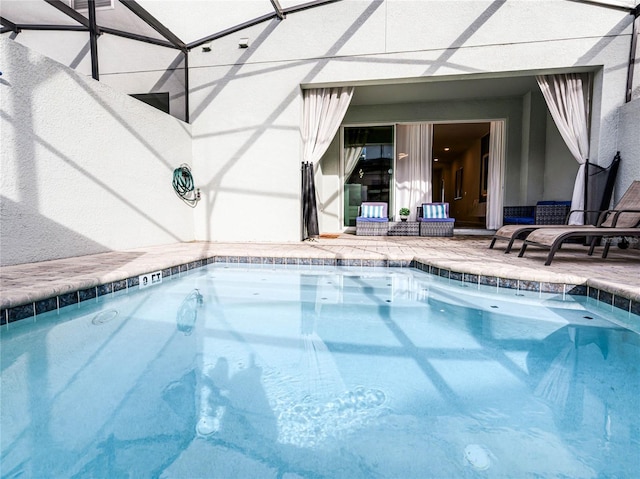 pool featuring a lanai and a patio