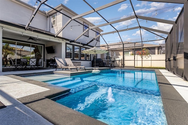 view of swimming pool with glass enclosure, a patio area, and a fenced in pool