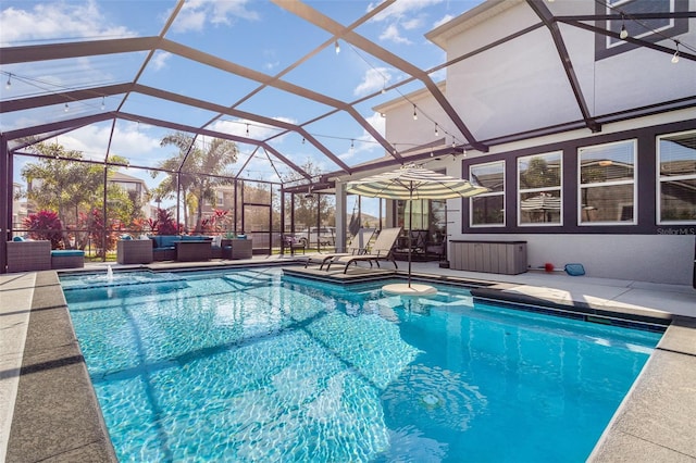 outdoor pool featuring glass enclosure, a patio, and outdoor lounge area