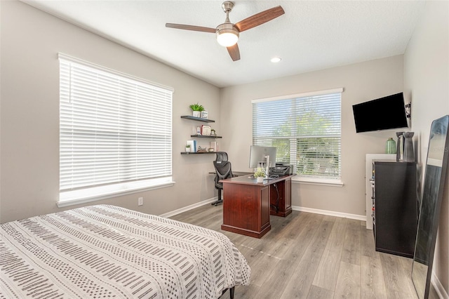 bedroom featuring light wood finished floors, recessed lighting, a ceiling fan, and baseboards