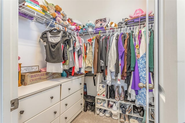 walk in closet with carpet floors