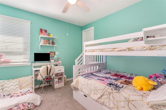 bedroom featuring ceiling fan, baseboards, and light colored carpet