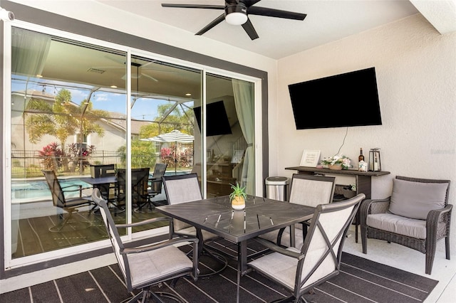 exterior space featuring outdoor dining area and ceiling fan