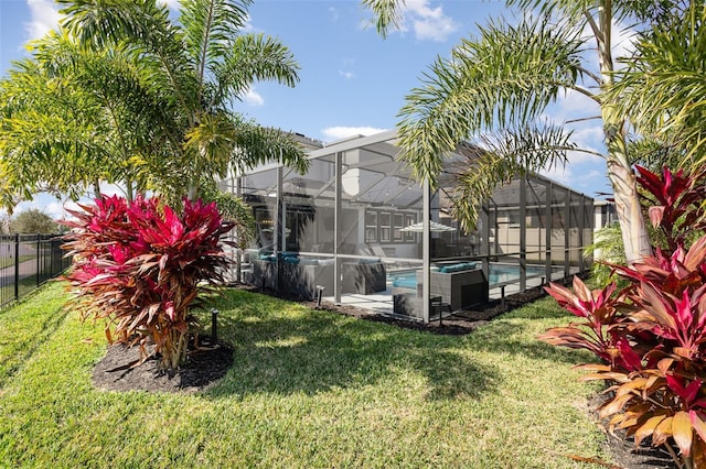 view of yard with glass enclosure, a fenced backyard, and a fenced in pool