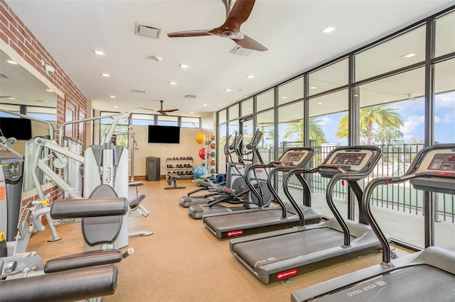 exercise room featuring ceiling fan, visible vents, and floor to ceiling windows