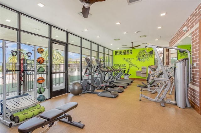 exercise room featuring visible vents, a ceiling fan, and floor to ceiling windows