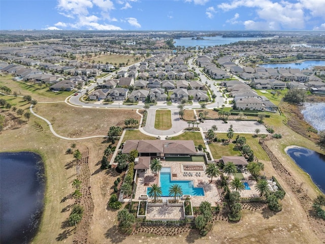 drone / aerial view featuring a water view and a residential view