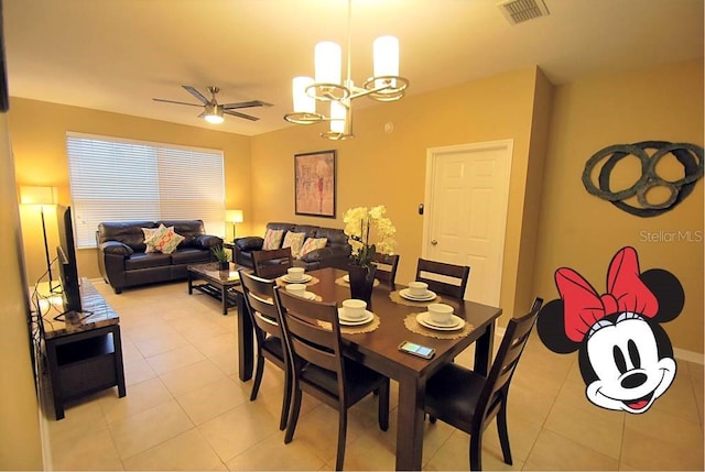 dining area with ceiling fan with notable chandelier, light tile patterned flooring, and visible vents