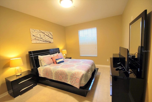 bedroom with baseboards and light tile patterned flooring