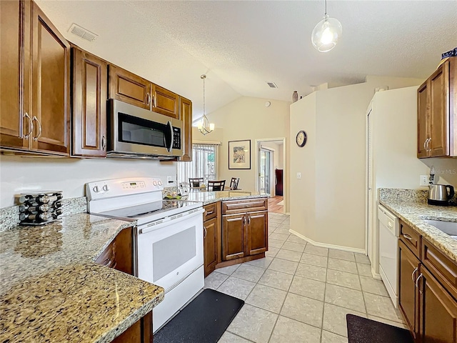 kitchen featuring white appliances, brown cabinetry, and decorative light fixtures