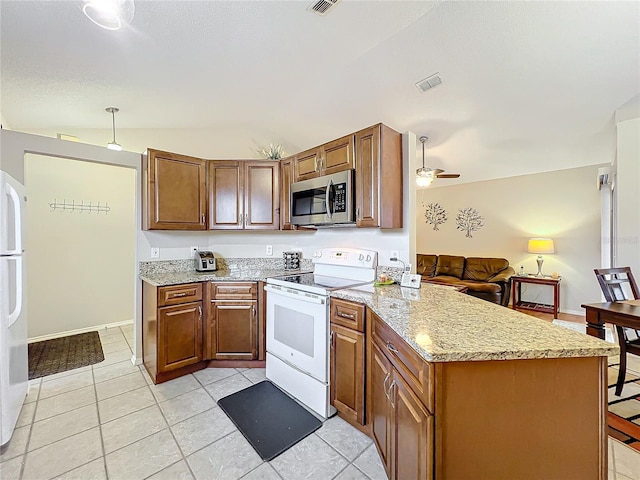 kitchen featuring a peninsula, white appliances, visible vents, and brown cabinets