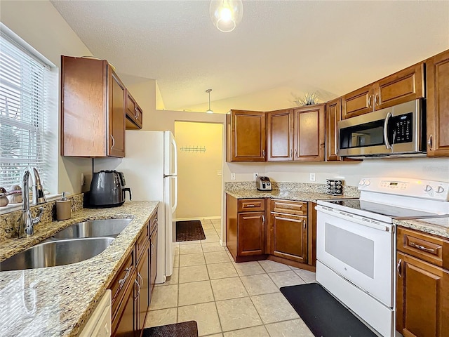 kitchen featuring lofted ceiling, light tile patterned floors, electric range, a sink, and stainless steel microwave