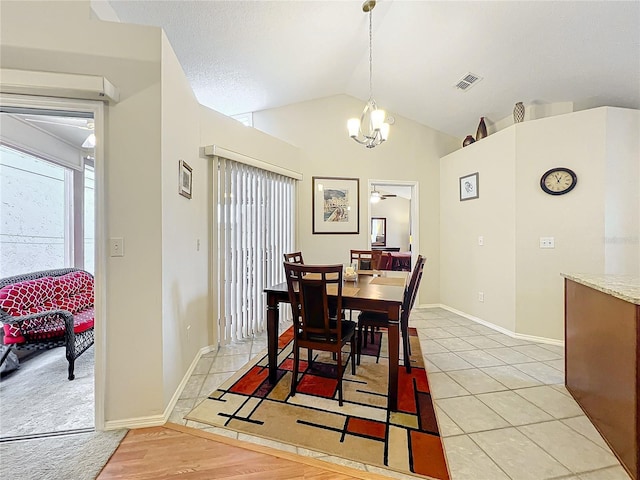 dining area with an inviting chandelier, visible vents, vaulted ceiling, and a wealth of natural light