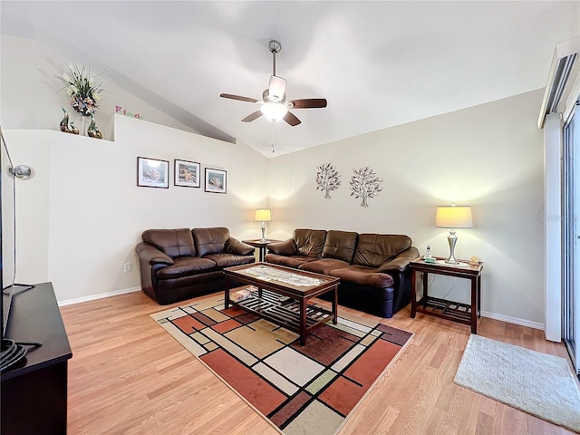 living area featuring a ceiling fan, baseboards, vaulted ceiling, and light wood finished floors