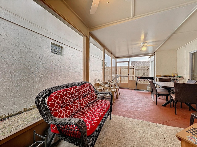 sunroom / solarium featuring a ceiling fan