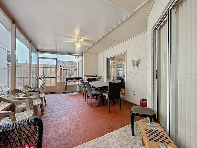 sunroom featuring a healthy amount of sunlight and a ceiling fan