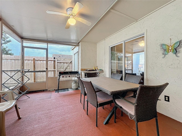 sunroom / solarium with a healthy amount of sunlight and ceiling fan