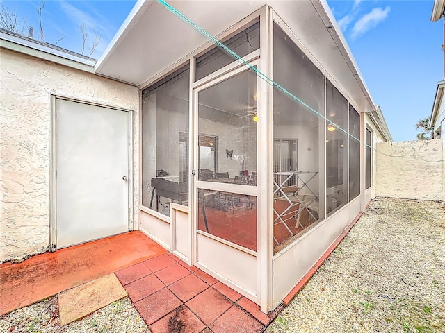 exterior space featuring a sunroom and fence