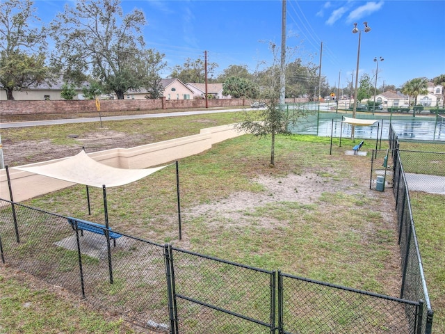 view of property's community featuring a water view and fence