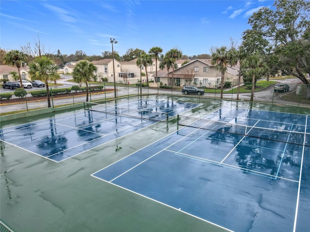 view of sport court featuring a residential view and fence