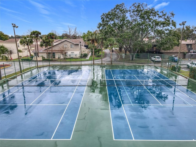 view of tennis court with fence