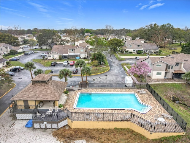 pool featuring a patio area, a residential view, and fence