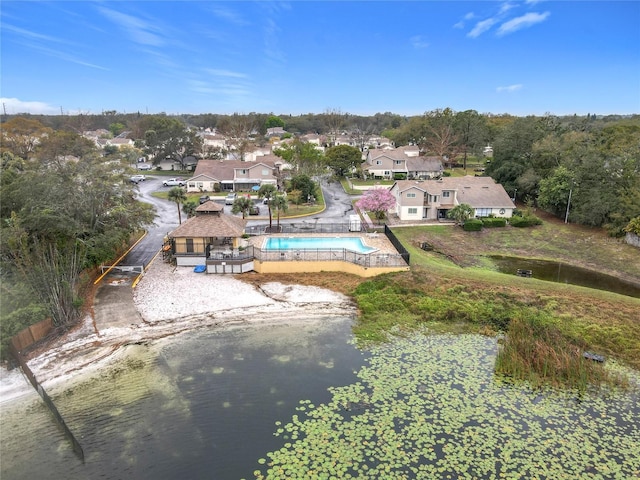 birds eye view of property with a water view and a residential view