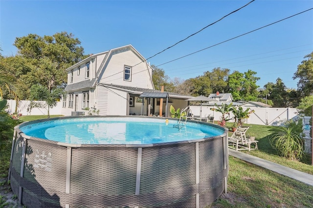 view of swimming pool featuring a fenced in pool, a fenced backyard, and a yard