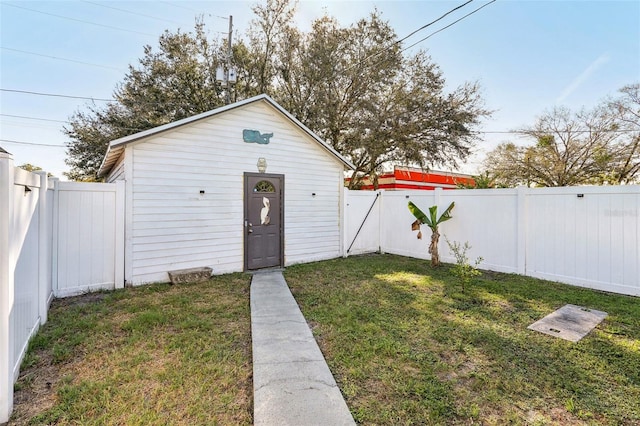 view of outbuilding featuring a fenced backyard and an outdoor structure