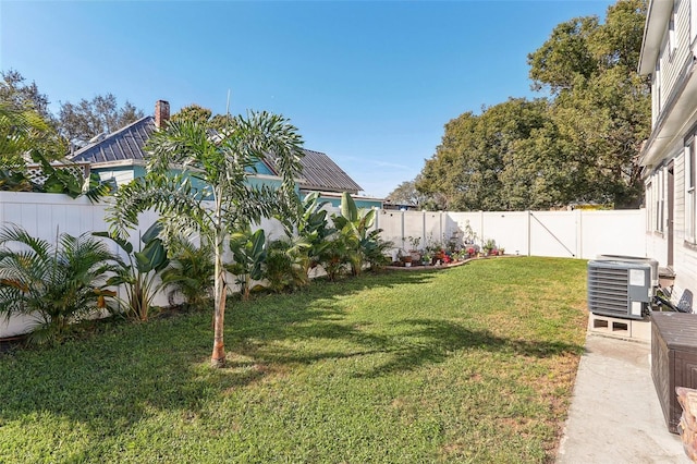 view of yard featuring a fenced backyard and central air condition unit