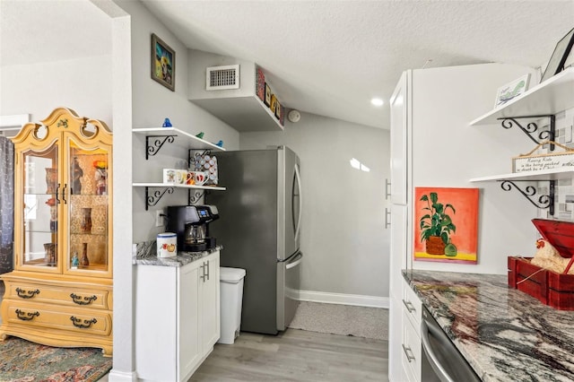 kitchen with open shelves, visible vents, stone countertops, white cabinets, and a textured ceiling