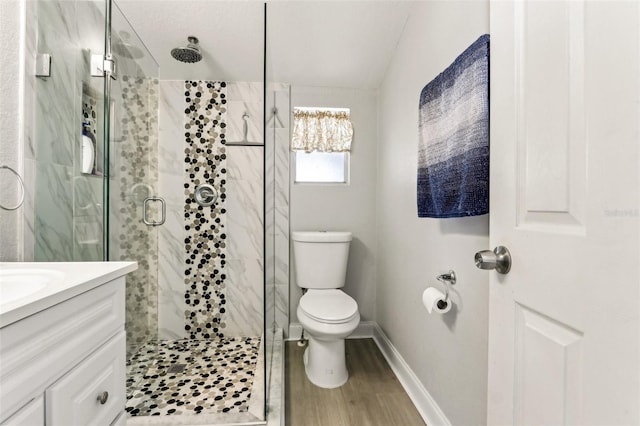 full bathroom with baseboards, toilet, wood finished floors, vanity, and a shower stall