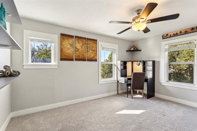 office space featuring carpet floors, ceiling fan, and baseboards