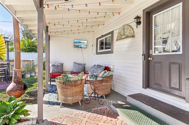 view of patio / terrace with covered porch and fence