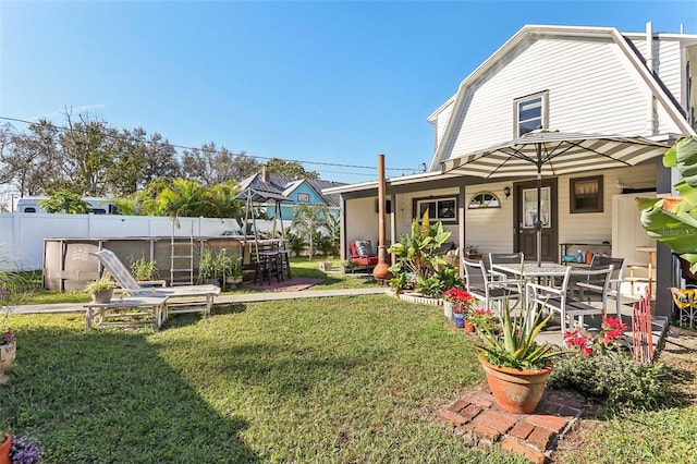 view of yard featuring a pool, a patio area, and fence