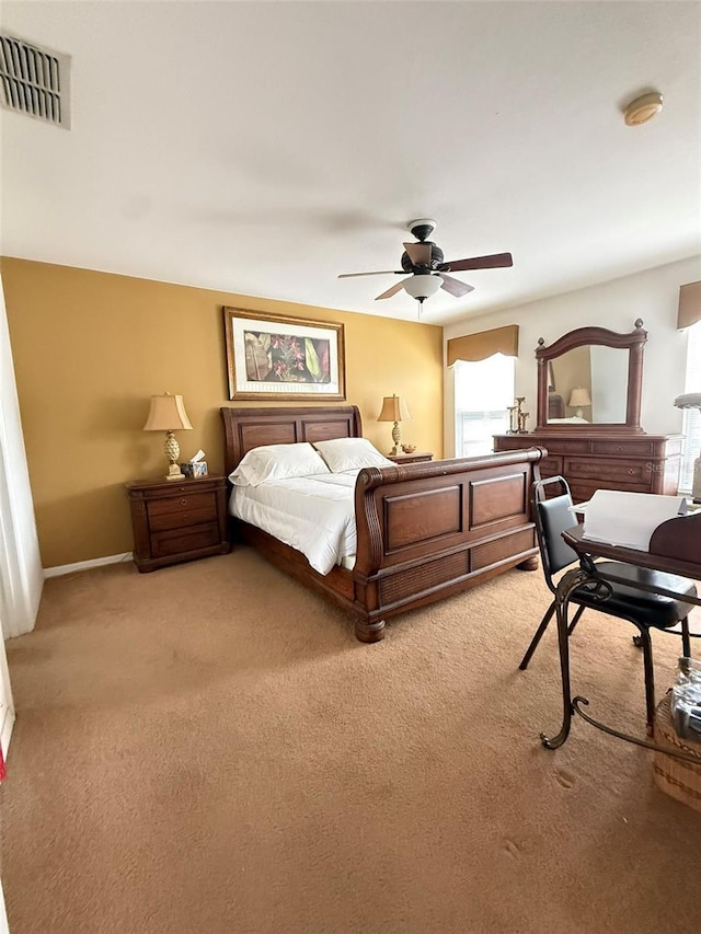 carpeted bedroom with ceiling fan, visible vents, and baseboards