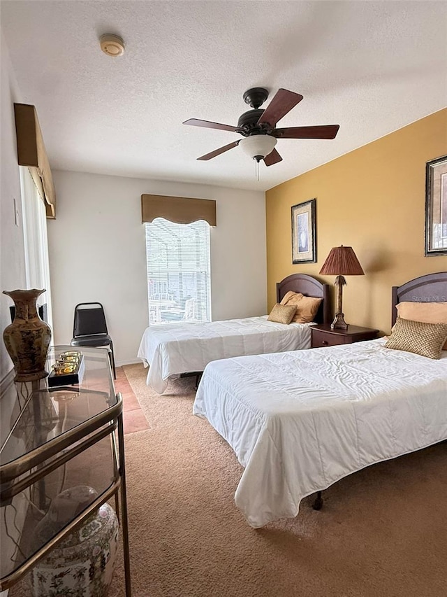 bedroom with light carpet, ceiling fan, and a textured ceiling